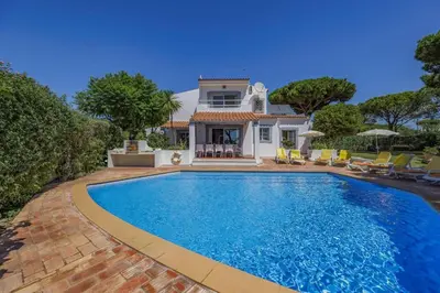 a swimming pool in front of a house at Villa Uma by Villa Plus in Loulé