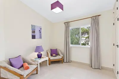 a living room with two chairs and a window at Villa Uma by Villa Plus in Loulé