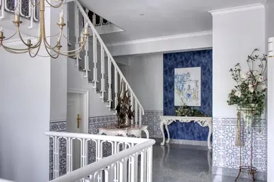 a staircase in a home with blue and white walls at Palacete da Baixa by MY CHOICE in Faro