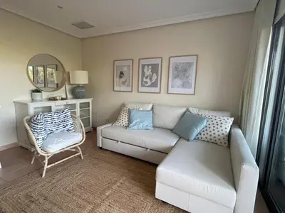a living room with a couch and a chair at Falesia Beach Apartment in Albufeira
