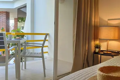 a bedroom with a bed and a table and a chair at Al-Charb Studio in Quarteira