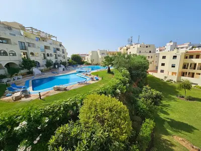 a resort with a swimming pool and some buildings at T1 Poente da Aldeia 336 Albufeira in Albufeira