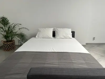 a large white bed with two pillows on it at Old Town House in Loulé