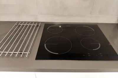 a stove top oven with a black stove top at Old Town House in Loulé