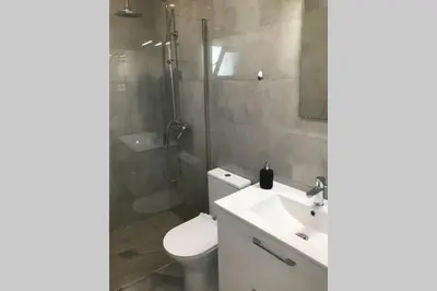 a bathroom with a toilet and a shower and a sink at Old Town House in Loulé