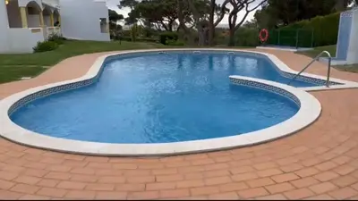 a large swimming pool with a brick driveway at Praia da Falésia Alfa Mar Albufeira in Olhos de Água
