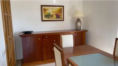 a dining room with a table and a picture on the wall at Praia da Falésia Alfa Mar Albufeira in Olhos de Água