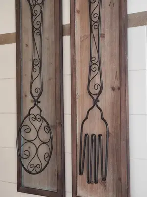 two pieces of utensils hanging on a wall at Casa Algarbe in Faro