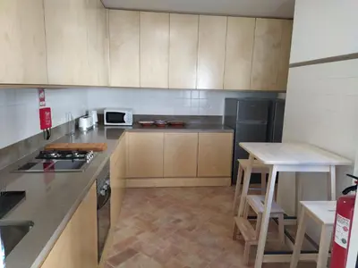 a kitchen with wooden cabinets and a counter top at Casa Algarbe in Faro
