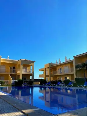 a swimming pool in front of some apartment buildings at Parra Holidays Q House in Guia