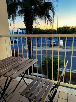 a wooden bench sitting on a balcony with a view of a street at Parra Holidays Q House in Guia