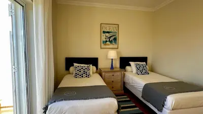 two beds in a small room with a window at Ellegance by Check-in Portugal in Vilamoura