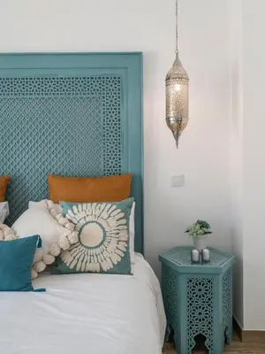 a bedroom with a bed with a blue headboard at Riad Matias Galé - Luxury Villa with private pool, AC, free wifi, 5 min from the beach in Guia