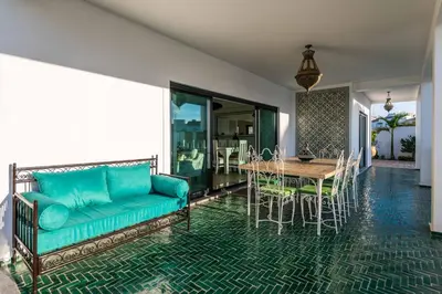 a living room with a couch and a table and chairs at Riad Matias Galé - Luxury Villa with private pool, AC, free wifi, 5 min from the beach in Guia
