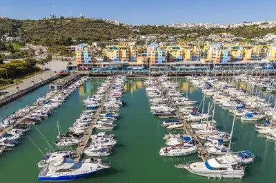 a group of boats docked in a harbor at Marina Breeze Apartment with Pool - 900m from the Beach in Albufeira