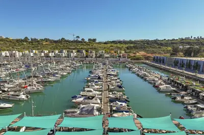 a bunch of boats are docked in a marina at Marina Breeze Apartment with Pool - 900m from the Beach in Albufeira