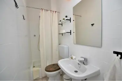 a bedroom with a bed and a ceiling fan at Ria Beach Studio in Faro