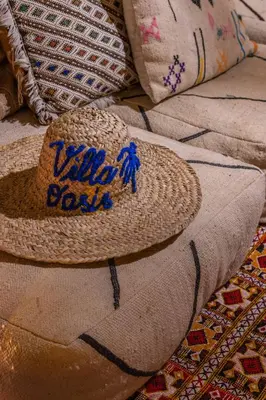 a straw hat is sitting on top of a pillow at Villa Oasis Galé - Luxury Villa with private pool, AC, free wifi, 5 min from the beach in Albufeira