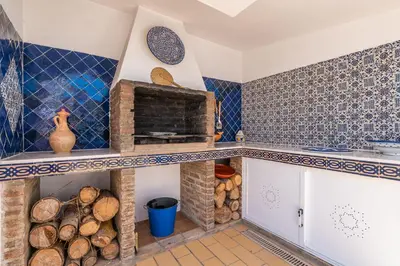 a kitchen with blue and white tiles on the wall at Villa Oasis Galé - Luxury Villa with private pool, AC, free wifi, 5 min from the beach in Albufeira