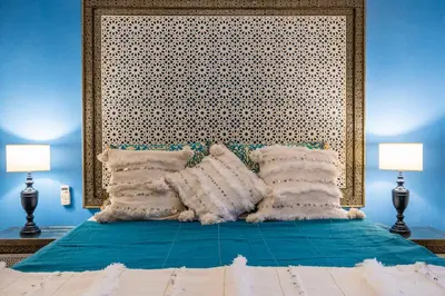 a blue bedroom with a bed with pillows on it at Villa Oasis Galé - Luxury Villa with private pool, AC, free wifi, 5 min from the beach in Albufeira