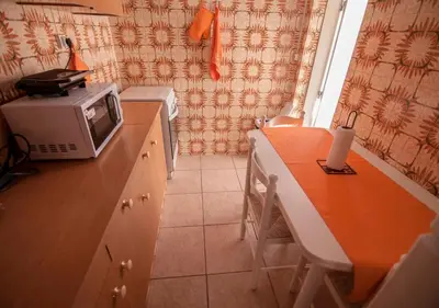 a small kitchen with a microwave on a counter at ALGARVE TYPICAL DOWNTOWN HOUSE in Faro