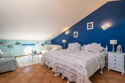 a bedroom with a large bed with blue walls at Villa Galé Sun - Luxury, 5bed with free wifi, AC, private pool, 5 min from the beach in Guia