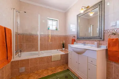 a bathroom with a tub and a sink and a shower at Riad Serpa Galé - Luxury, private pool, AC, wifi, 5 min from the beach in Guia