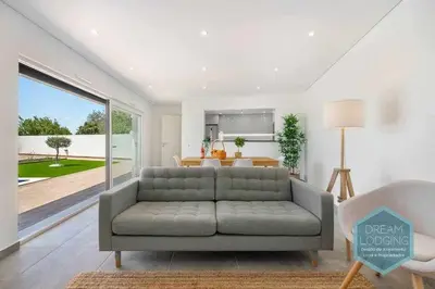 a living room with a gray couch and a table at Casa do Alto - Dream Lodging in Albufeira