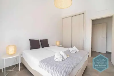 a bedroom with a large white bed with towels on it at Casa do Alto - Dream Lodging in Albufeira