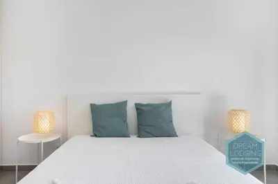 a bedroom with a bed with blue pillows and two lamps at Casa do Alto - Dream Lodging in Albufeira