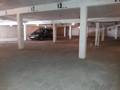 a parking garage with a car parked in it at Quarteira 1-Bed Sleeps 4 Parking 1 min to Beach in Quarteira