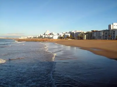 a view of a beach with a city in the background at Quarteira 1-Bed Sleeps 4 Parking 1 min to Beach in Quarteira