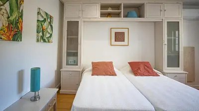 a bedroom with two beds and a tv in it at Villa Mar Ali - JACUZZI - 400m from the beach - BY BEDZY in Albufeira