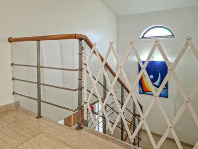 a staircase with a gate and a window at Villa Mar Ali - JACUZZI - 400m from the beach - BY BEDZY in Albufeira