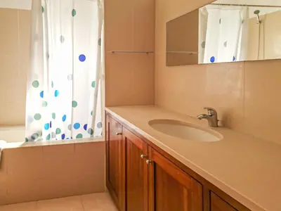 a bathroom with a sink and a shower curtain at Villa Mar Ali - JACUZZI - 400m from the beach - BY BEDZY in Albufeira