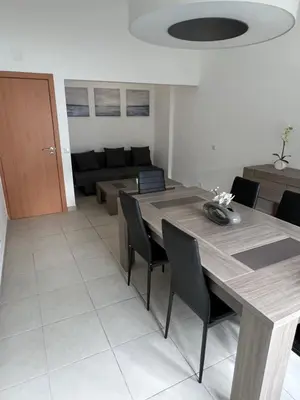 a dining room with a table and chairs and a couch at Plage in Albufeira