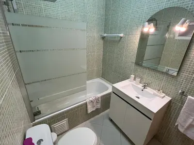 a bathroom with a sink and a toilet and a tub at Plage in Albufeira