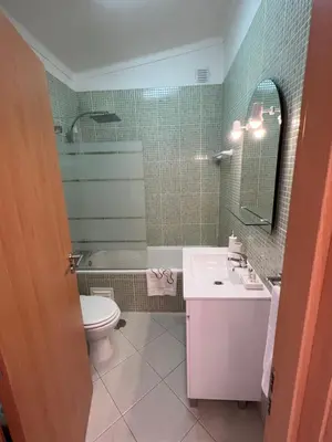 a bathroom with a sink and a toilet and a mirror at Plage in Albufeira