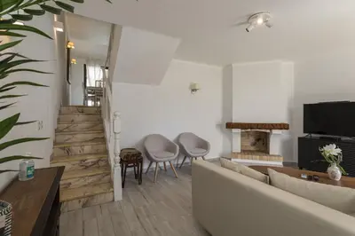 a living room with a couch and a tv at Vilamoura Garden House with Pool & Parking, by Hopstays in Quarteira