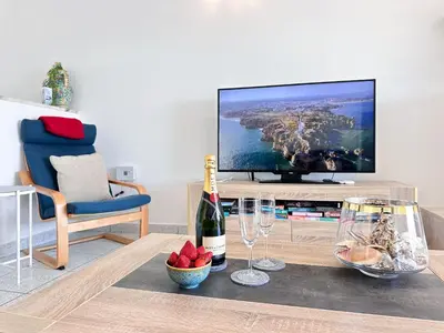 a bottle of wine on a table in a living room at Sea & Sun WindMill Apartment by Be Cherish in Albufeira