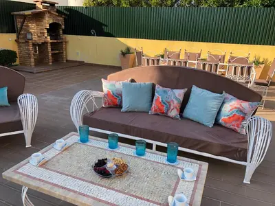 a couch sitting on a patio with a table at Villa Mar Azul in Albufeira
