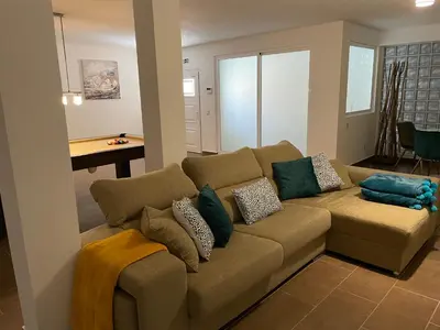 a living room with a brown couch with pillows at Villa Mar Azul in Albufeira