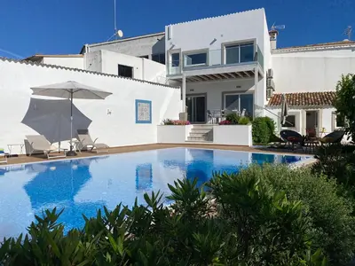 a large swimming pool in front of a house at Casa Bravo in Querença