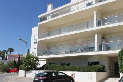 a black car parked in front of a building at AP Casa Monte da Balaia in Albufeira