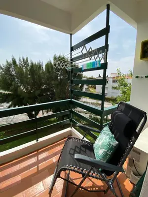 a chair on a balcony with a view of the beach at Neptuno IV - Vilamoura in Quarteira