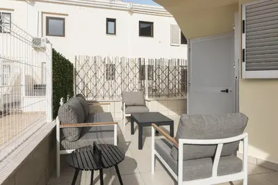 a balcony with two chairs and a table at Marina Luxor - Vilamoura in Quarteira