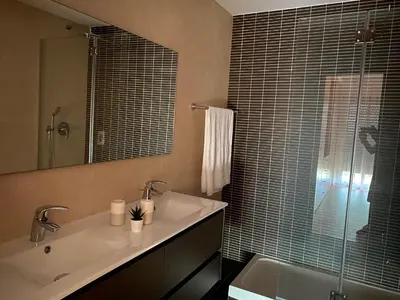 a bathroom with a sink and a mirror and a tub at Wonderful View - Quinta da Colina C8 in Albufeira