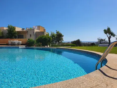 a swimming pool in a villa with blue water at Wonderful View - Quinta da Colina C8 in Albufeira