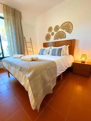 a hallway with a mirror and a bathroom with a tub at Residence Golf Club Vilamoura by Be Cherish in Quarteira