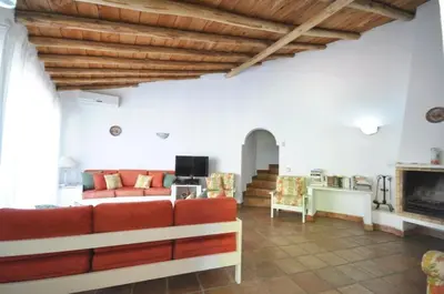 a bedroom with a bed and a table with a lamp at Fantastic outdoor area, private pool, Tennis Court Golf Practice Facility in Faro